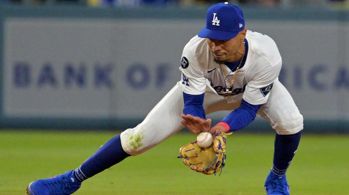 Los Angeles Dodgers shortstop Mookie Betts (50) makes a play and throws out Atlanta Braves designated hitter Marcell Ozuna (20) at first base in the eighth inning at Dodger Stadium.