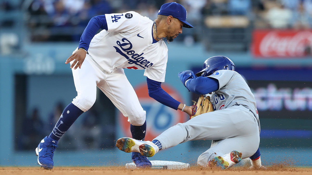 Los Angeles Dodgers shortstop Mookie Betts (50) catches Chicago Cubs second base Nico Hoerner (2) stealing second base during the eighth inning of the game at Dodger Stadium. Mandatory Credit: Kiyoshi Mio-Imagn Images