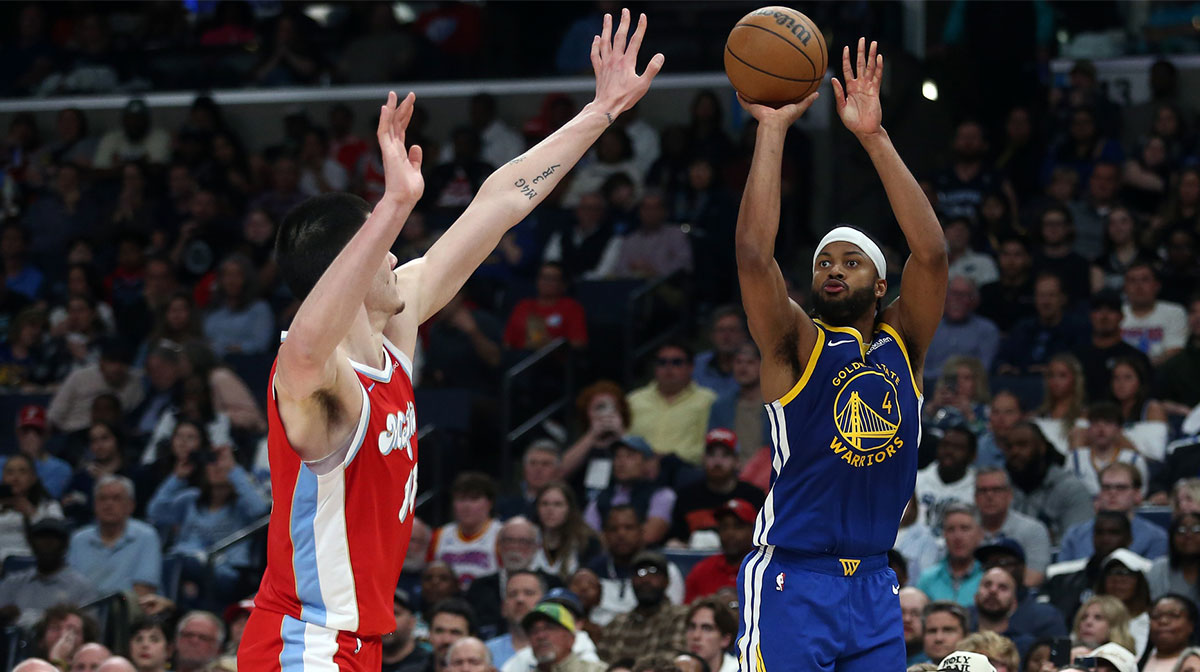Golden State Warriors guard Moses Moody (4) shoots for three as Memphis Grizzlies center Zach Edey (14) defends during the third quarter at FedExForum.