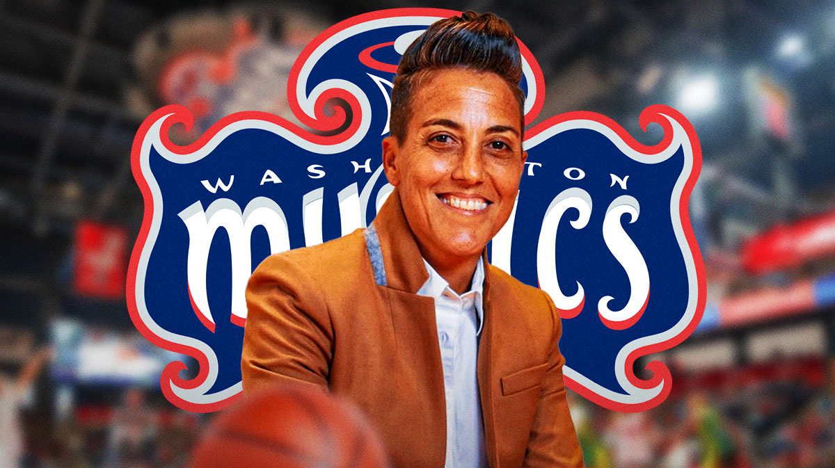 Washington Mystics general manager Jamila Wideman smiling, with the Mystics logo in the background