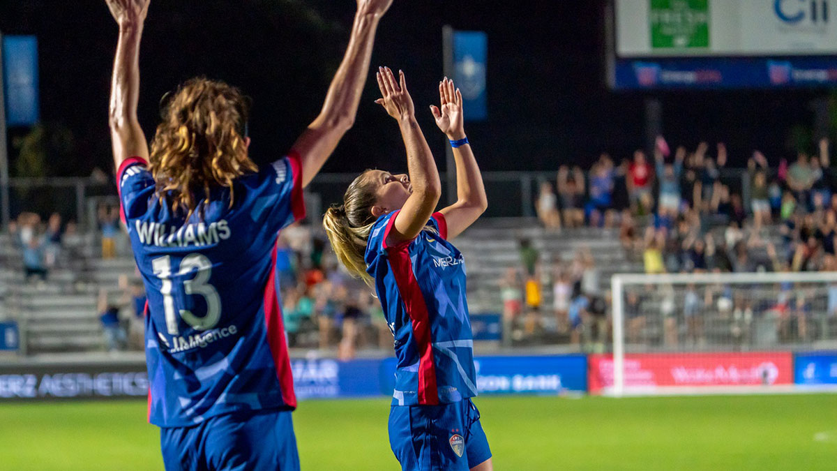North Carolina Courage midfielder Ashley Sanchez (2) and defender Ryan Williams (13) celebrate a goal during the second half at First Horizon Stadium at WakeMed Soccer Park.
