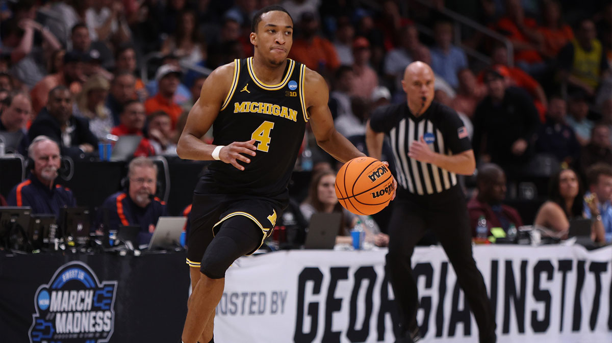 Michigan Wolverines guard Nimari Burnett (4) dribbles in the second half of a South Regional semifinal of the 2025 NCAA tournament against the Auburn Tigers at State Farm Arena.