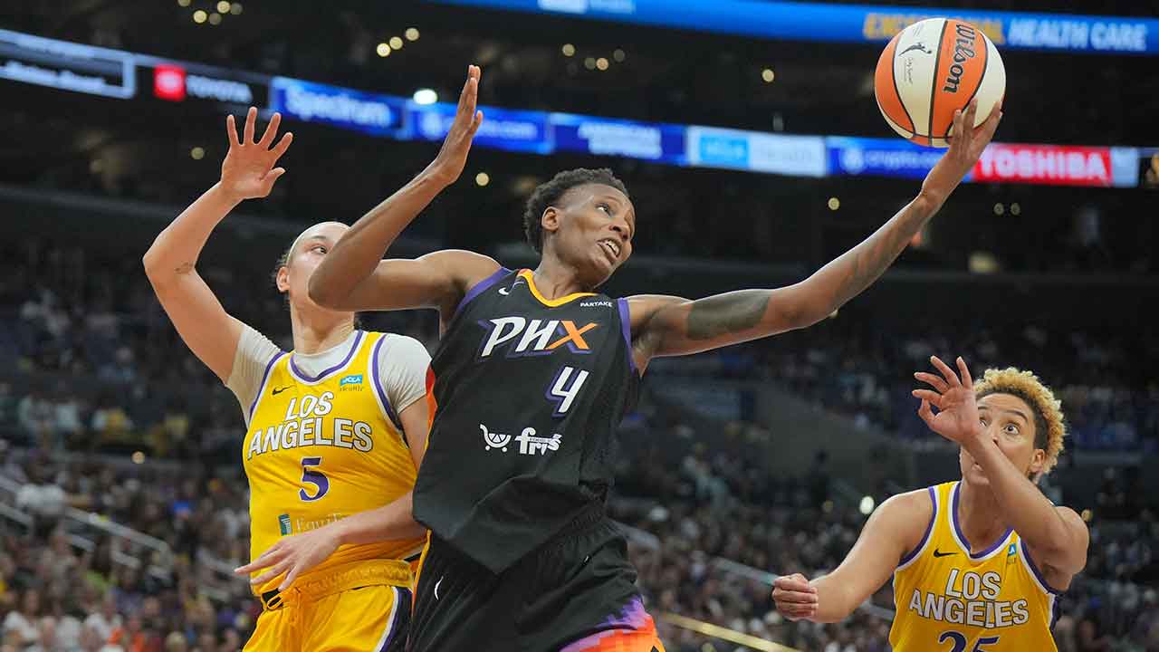 Phoenix Mercury forward Natasha Mack (4) reaches for the ball against LA Sparks forward Dearica Hamby (5) and guard Layshia Clarendon (25) in the first half at Crypto.com Arena.