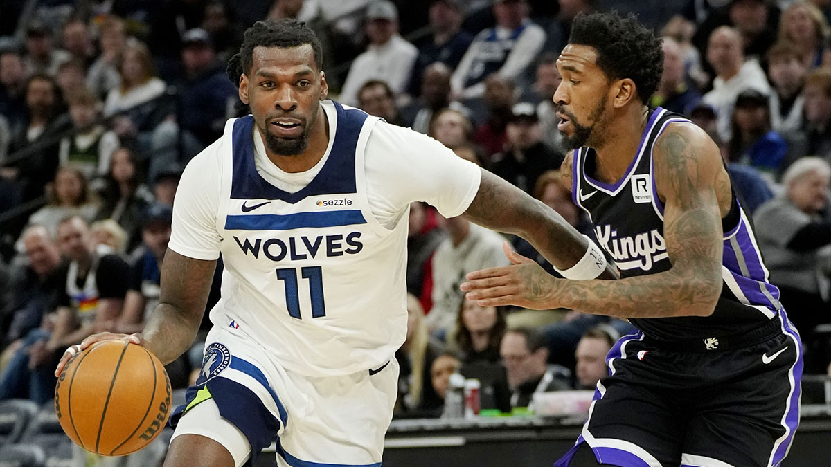Minnesota Timberwolves center Naz Reid (11) works past Sacramento Kings guard Malik Monk (0) in the first quarter at Target Center.