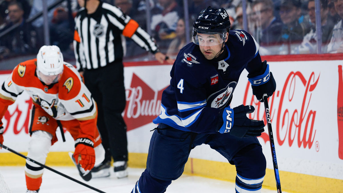 Winnipeg Jets defenseman Neal Pionk (4) skates away from Anaheim Ducks forward Trevor Zegras (11) during the first period at Canada Life Centre.