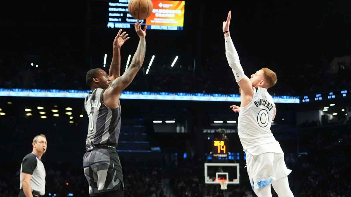 Brooklyn Nets forward Dariq Whitehead (0) shoots a three point jump shot over Minnesota Timberwolves shooting guard Donte DiVincenzo (0) during the first half at Barclays Center.