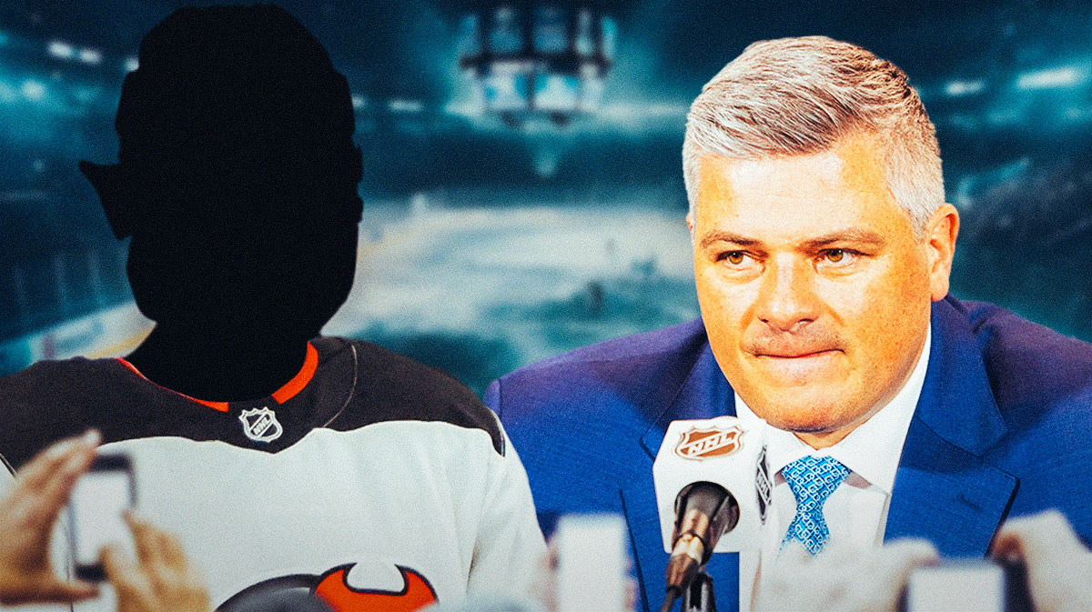 Sheldon Keefe in middle looking stern, 1 silhouetted player in a New Jersey Devils jersey on each side (no C or A on jersey), hockey rink in background