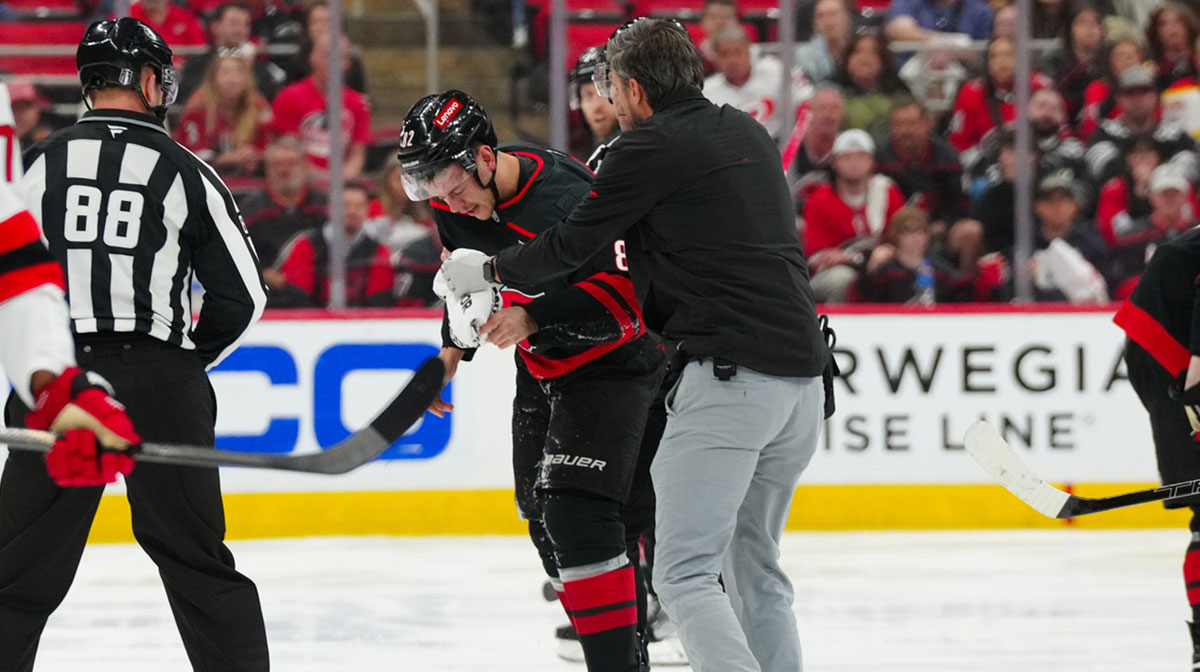 Carolina Hurricanes center Jesperi Kotkaniemi (82) is high sticked by New Jersey Devils center Dawson Mercer (91) (not shown) in the second overtime in game five of the first round of the 2025 Stanley Cup Playoffs at Lenovo Center.