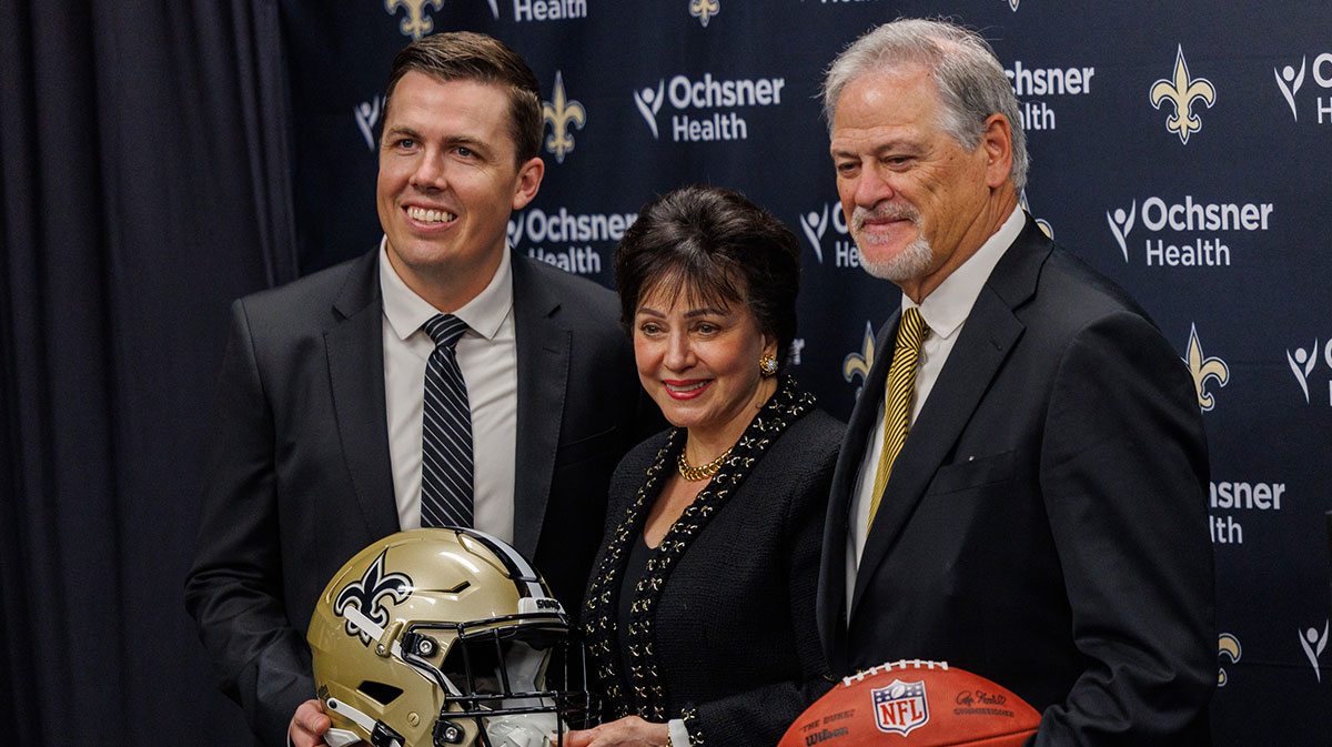 New Orleans Saints owner Gayle Benson poses with head coach Kellen Moore and general manager Mickey Loomis at Ochsner Sports Performance Center.