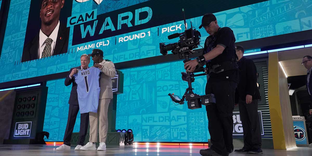 Quarterback Cam Ward from Miami poses with NFL Commissioner Roger Goodell after being selected 1st overall by the Tennessee Titans during the first round of the 2025 NFL Draft at Lambeau Field