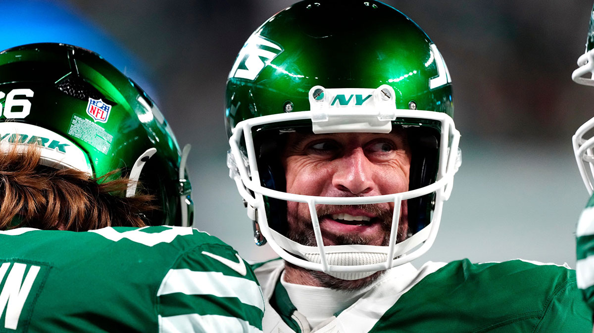 New York Jets quarterback Aaron Rodgers (8) smiles after throwing his fourth touchdown pass of the day, Sunday January 5, 2025, in East Rutherford.