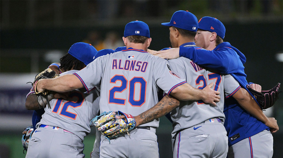 New York Mets shortstop Francisco Lindor (12) and first base Pete Alonso (20) and third base Mark Vientos (27) embrace team mates after defeating the Athletics at Sutter Health Park.
