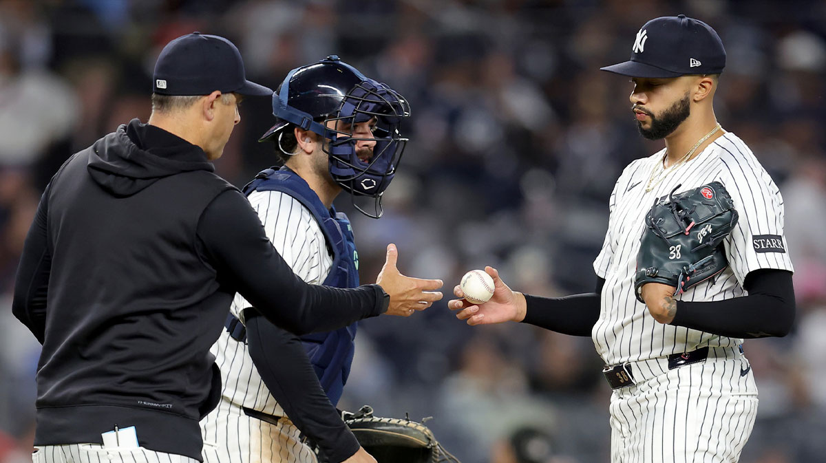 New York Yankees manager Aaron Boone (17) takes the ball from relief pitcher Devin Williams (38) during a pitching change during the ninth inning against the Toronto Blue Jays at Yankee Stadium.