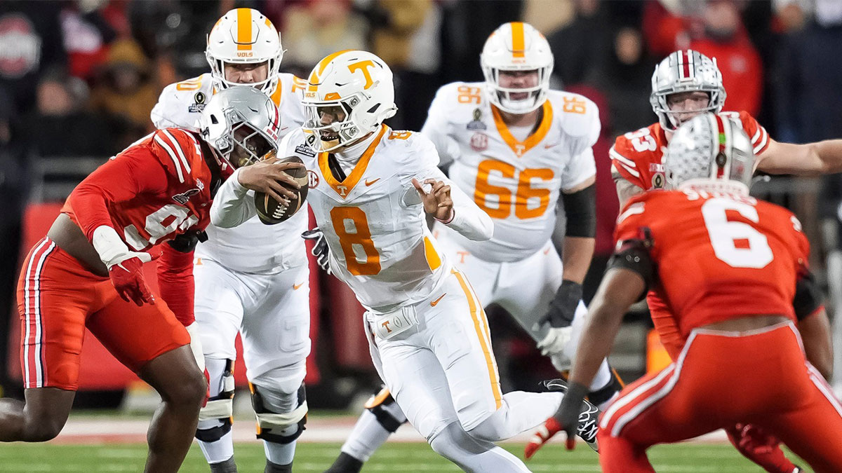 Tennessee quarterback Nico Iamaleava (8) scrambles between Ohio State defenders during a College Football Playoff first round game between Tennessee and Ohio State held at Ohio Stadium in Columbus, Ohio, on Saturday, Dec. 21, 2024.