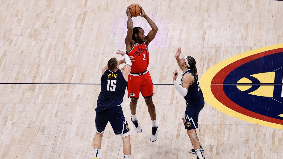 Los Angeles Clippers forward Kawhi Leonard (2) controls the ball as Denver Nuggets center Nikola Jokic (15) and forward Aaron Gordon (32) defend in the fourth quarter during game two of first round for the 2025 NBA Playoffs at Ball Arena.
