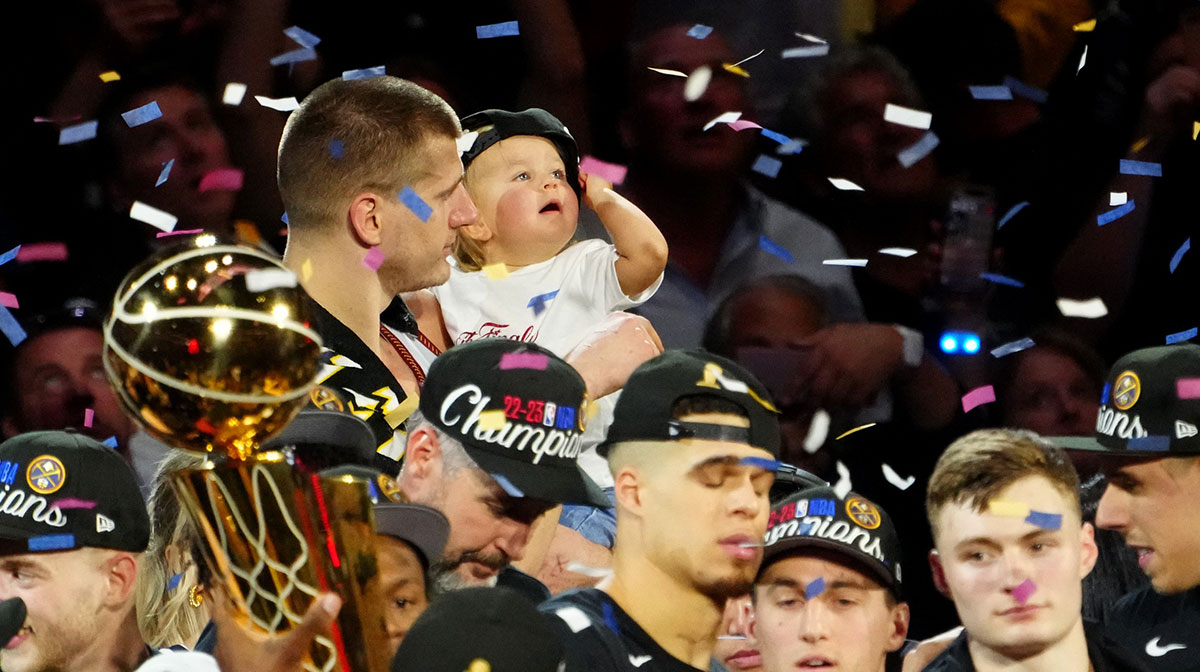 Denver Nuggets center Nikola Jokic (15) and his daughter celebrate after the Nuggets won the 2023 NBA Championship against the Miami Heat at Ball Arena.