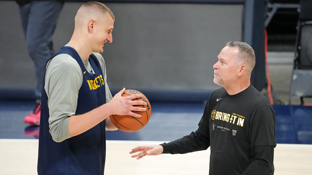 Denver Nuggets center Nikola Jokic (15) talks with head coach Michael Malone during a practice session on media day before the 2023 NBA Finals at Ball Arena.
