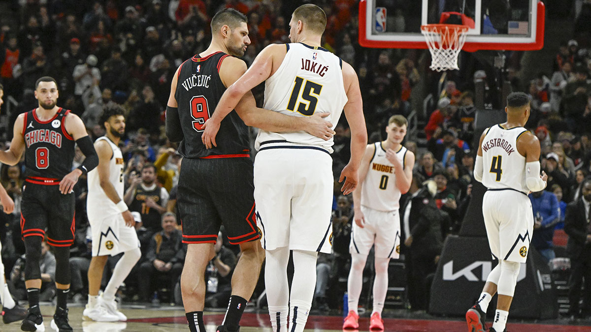 Chicago Bulls center Nikola Vucevic (9) and Denver Nuggets center Nikola Jokic (15) hug after a game at the United Center.