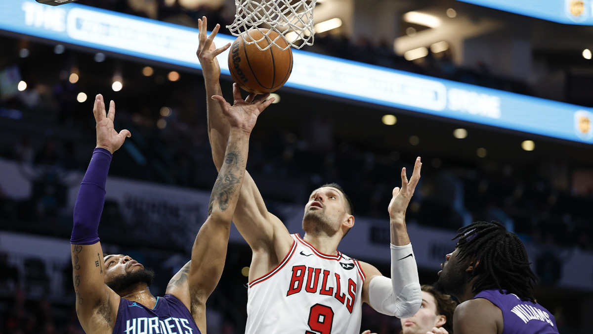 Chicago Bulls center Nikola Vucevic (9) and Charlotte Hornets forward Miles Bridges (0) fight for a rebound during the second half at Spectrum Center.