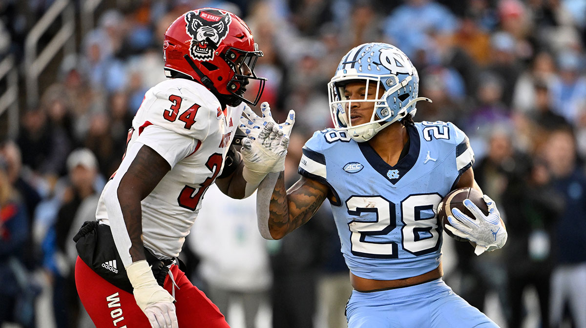 North Carolina Tar Heels running back Omarion Hampton (28) with the ball as North Carolina State Wolfpack linebacker Kamal Bonner (34) defends in the first quarter at Kenan Memorial Stadium.