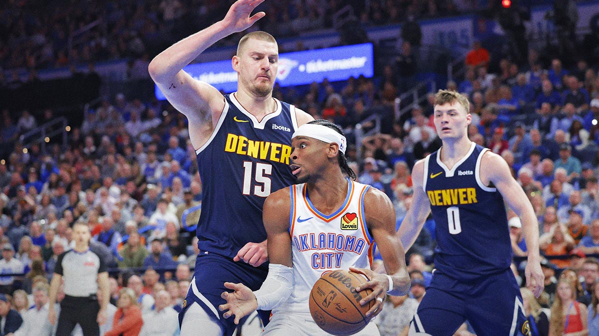 Nuggets center Nikola Jokic (15) defends a drive by Oklahoma City Thunder guard Shai Gilgeous-Alexander (2) during the second half at Paycom Center