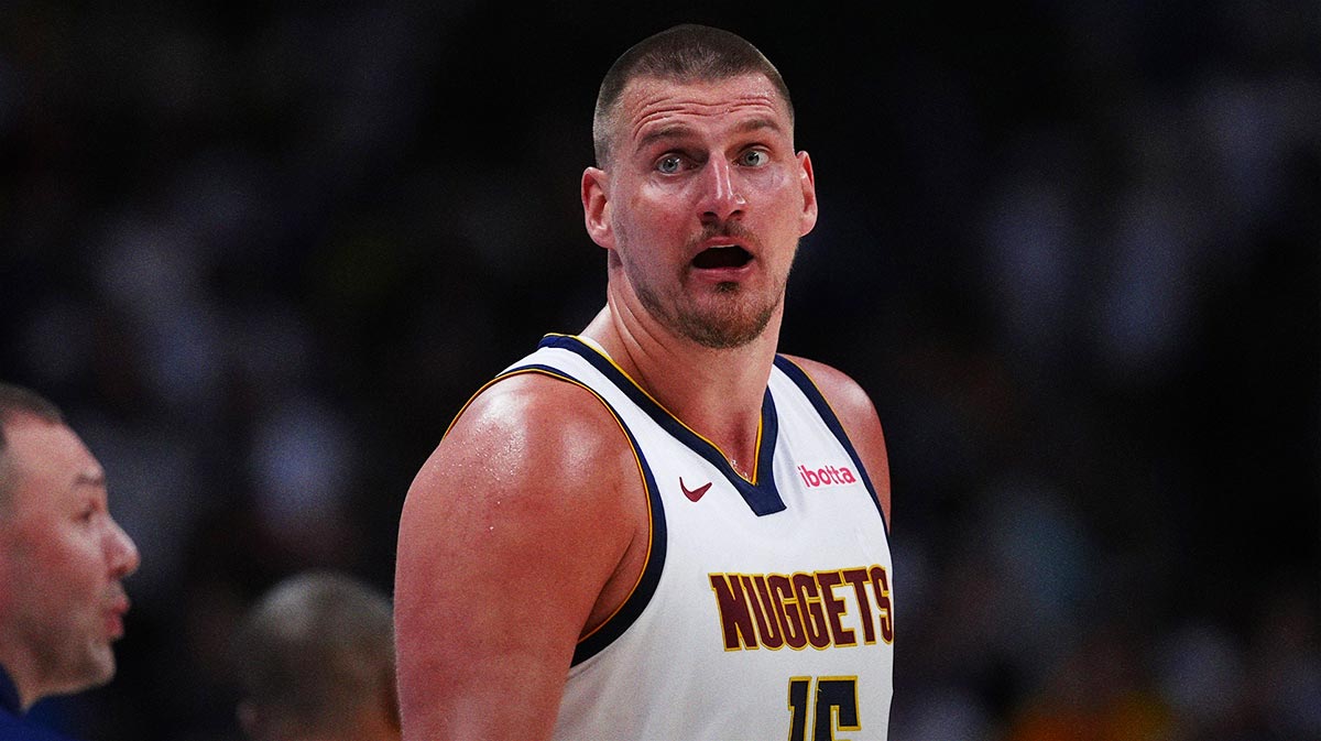 Nuggets center Nikola Jokic (15) reacts in the fourth quarter against the Memphis Grizzlies at Ball Arena next to Bill Simmons