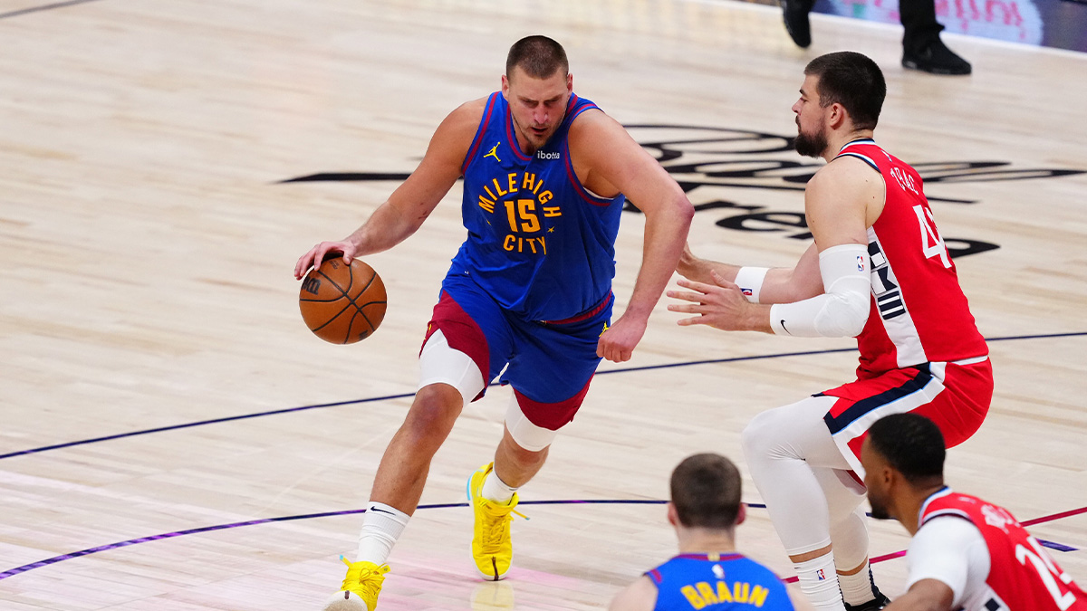 Denver Nuggets center Nikola Jokic (15) drives at LA Clippers center Ivica Zubac (40) in the second quarter at Ball Arena.