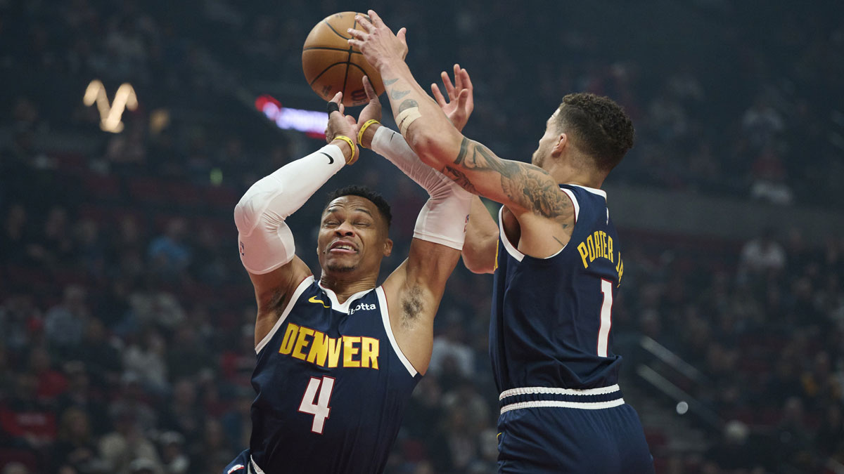 Denver Nuggets guard Russell Westbrook (4) and forward Michael Porter Jr. (1) grab a defensive rebound during the first half against the Portland Trail Blazers at Moda Center.