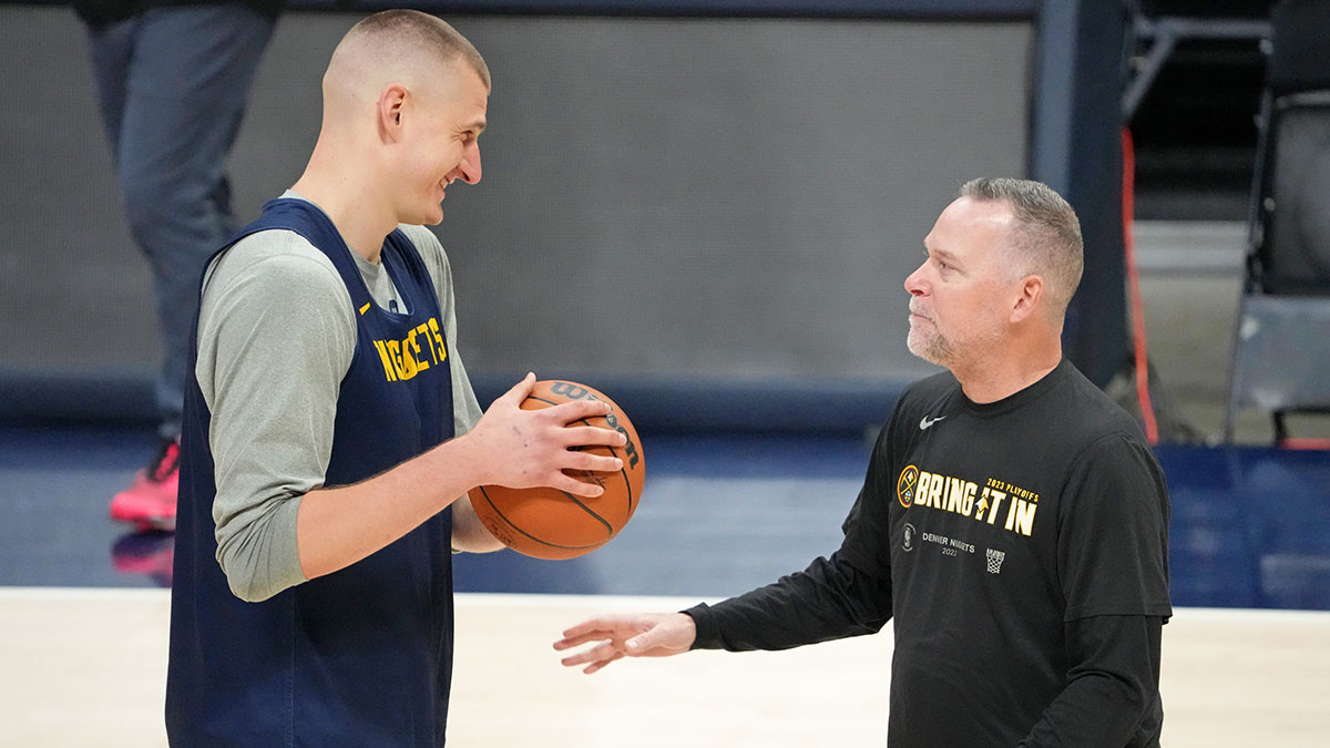 Denver Nuggets center Nikola Jokic (15) talks with head coach Michael Malone during a practice session on media day before the 2023 NBA Finals at Ball Arena.