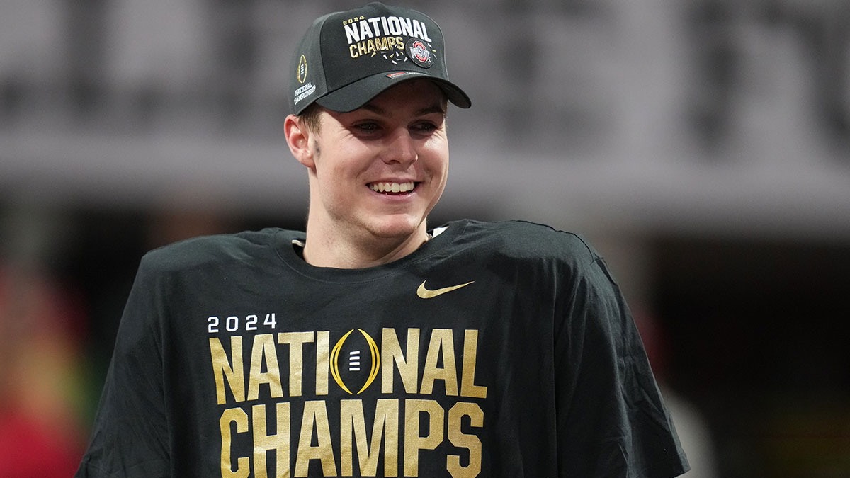Ohio State Buckeyes quarterback Will Howard (18) on the podium after defeating the Notre Dame Fighting Irish in the CFP National Championship college football game at Mercedes-Benz Stadium.