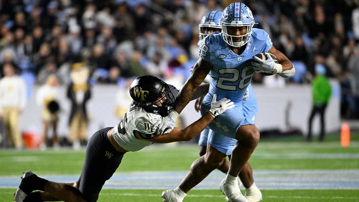 North Carolina Tar Heels running back Omarion Hampton (28) runs as Wake Forest Demon Deacons defensive back Nick Andersen (45) defends in the third quarter at Kenan Memorial Stadium.