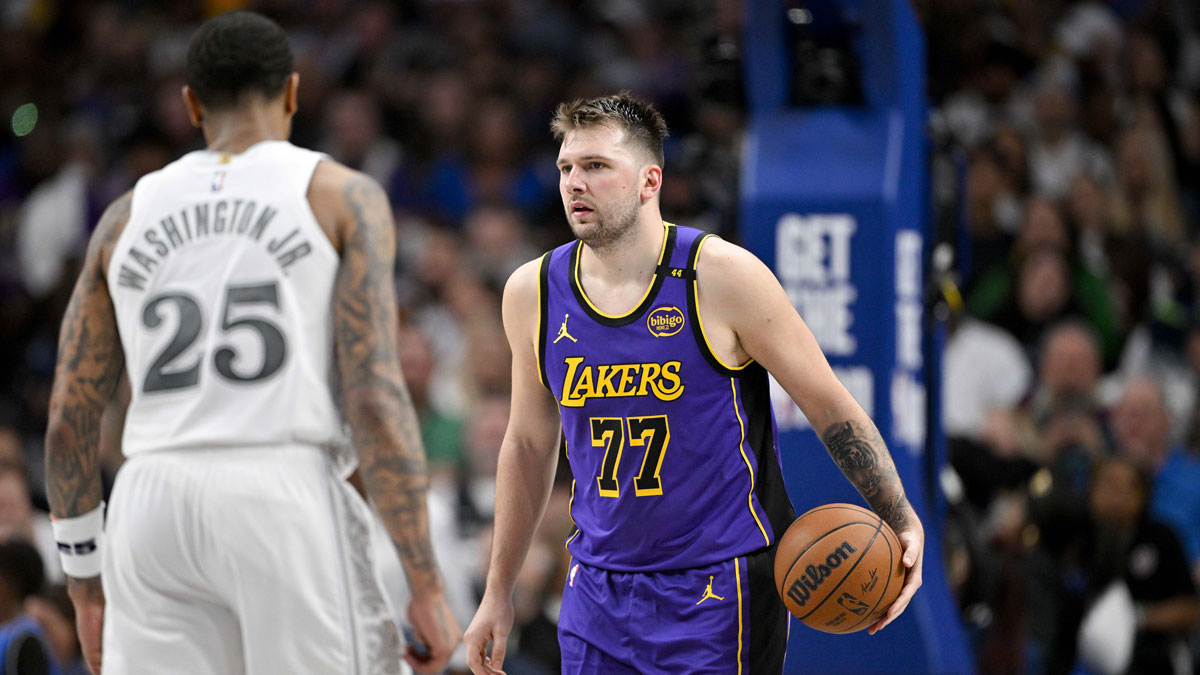 Dallas Mavericks forward P.J. Washington (25) and Los Angeles Lakers guard Luka Doncic (77) in action during the game between the Dallas Mavericks and the Los Angeles Lakers at American Airlines Center.
