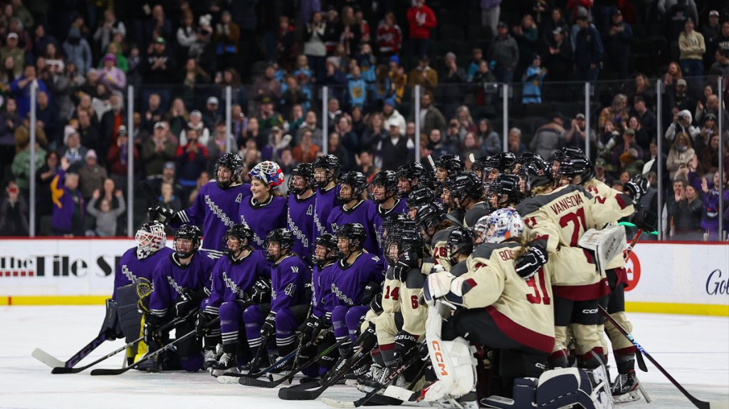 Minnesota and Montreal players pose for a photo after a PWHL ice hockey game.