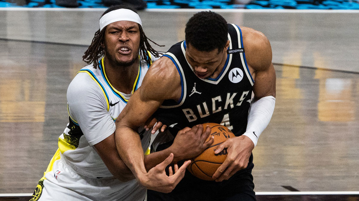Pacers center Myles Turner (33) and Milwaukee Bucks forward Giannis Antetokounmpo (34) fight for the ball
