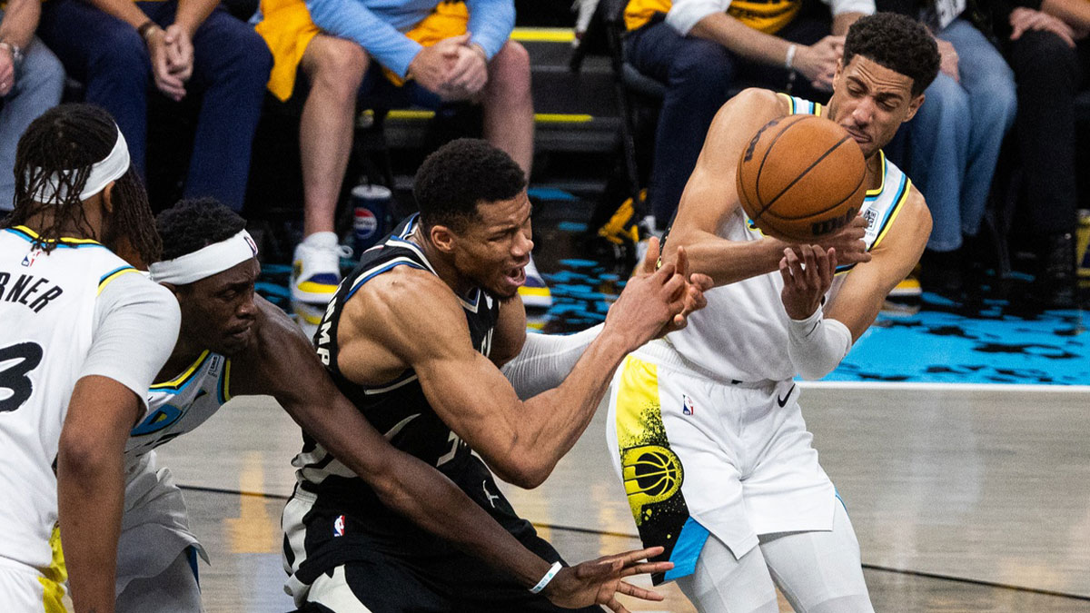 Indiana Pacers guard Tyrese Haliburton (0) steals the ball from Milwaukee Bucks forward Giannis Antetokounmpo (34) during game five of the first round for the 2024 NBA Playoffs at Gainbridge Fieldhouse.