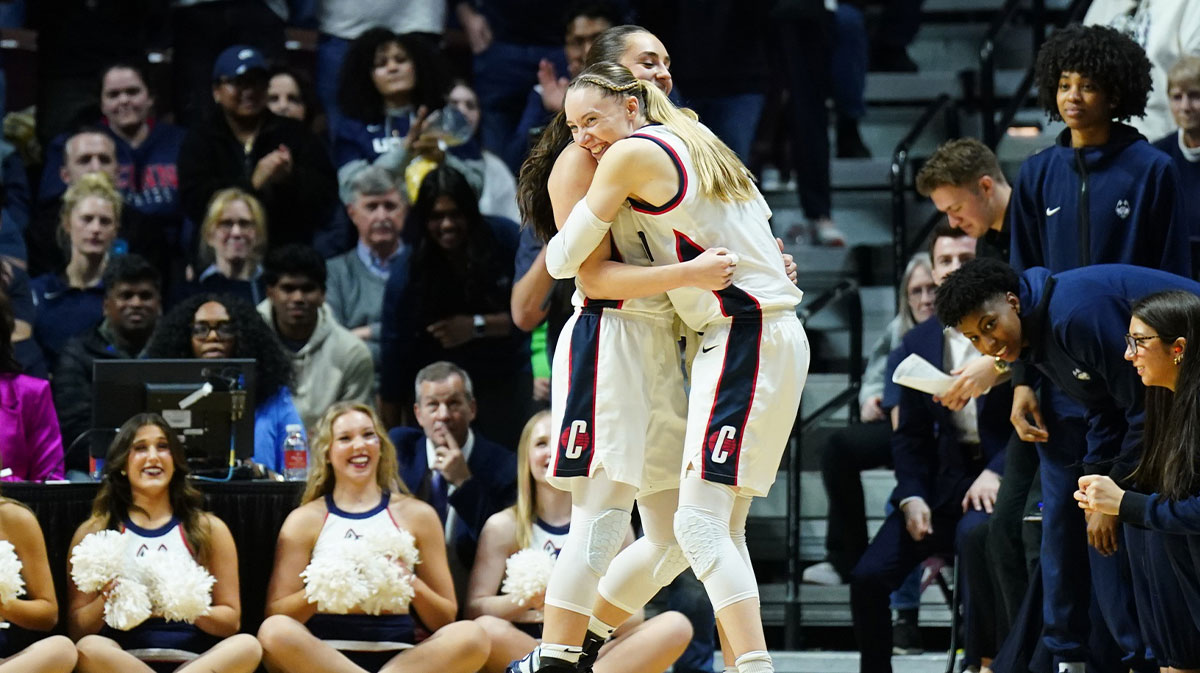 UConn Huskies guard Paige Bueckers (5) hugs guard Nika Muhl (10) late in the fourth quarter as they take on the Georgetown Hoyas.