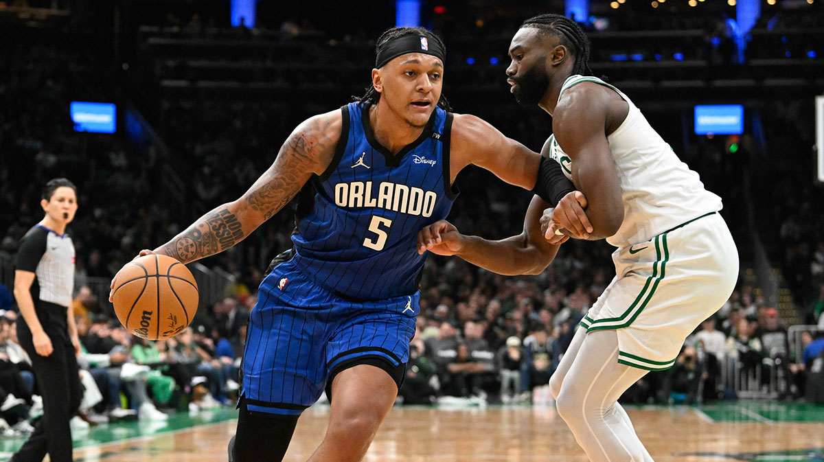 Orlando Magic forward Paolo Banchero (5) dribbles the ball against Boston Celtics guard Jaylen Brown (7) during the first half at TD Garden.