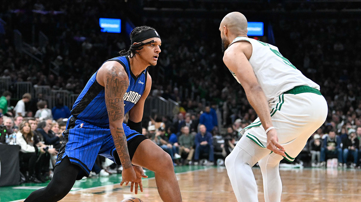 Orlando Magic forward Paolo Banchero (5) dribbles the ball against the defense of Boston Celtics guard Derrick White (9) during the first half at TD Garden.