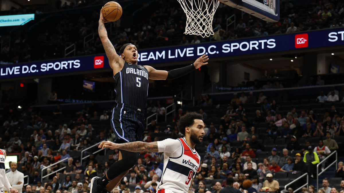 Orlando Magic forward Paolo Banchero (5) dunks the ball as Washington Wizards forward Justin Champagnie (9) defends in the first half at Capital One Arena.
