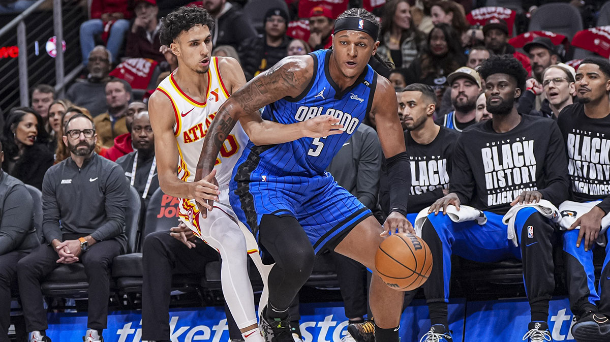 Orlando Magic forward Paolo Banchero (5) is defended by Atlanta Hawks forward Zaccharie Risacher (10) during the first half at State Farm Arena.