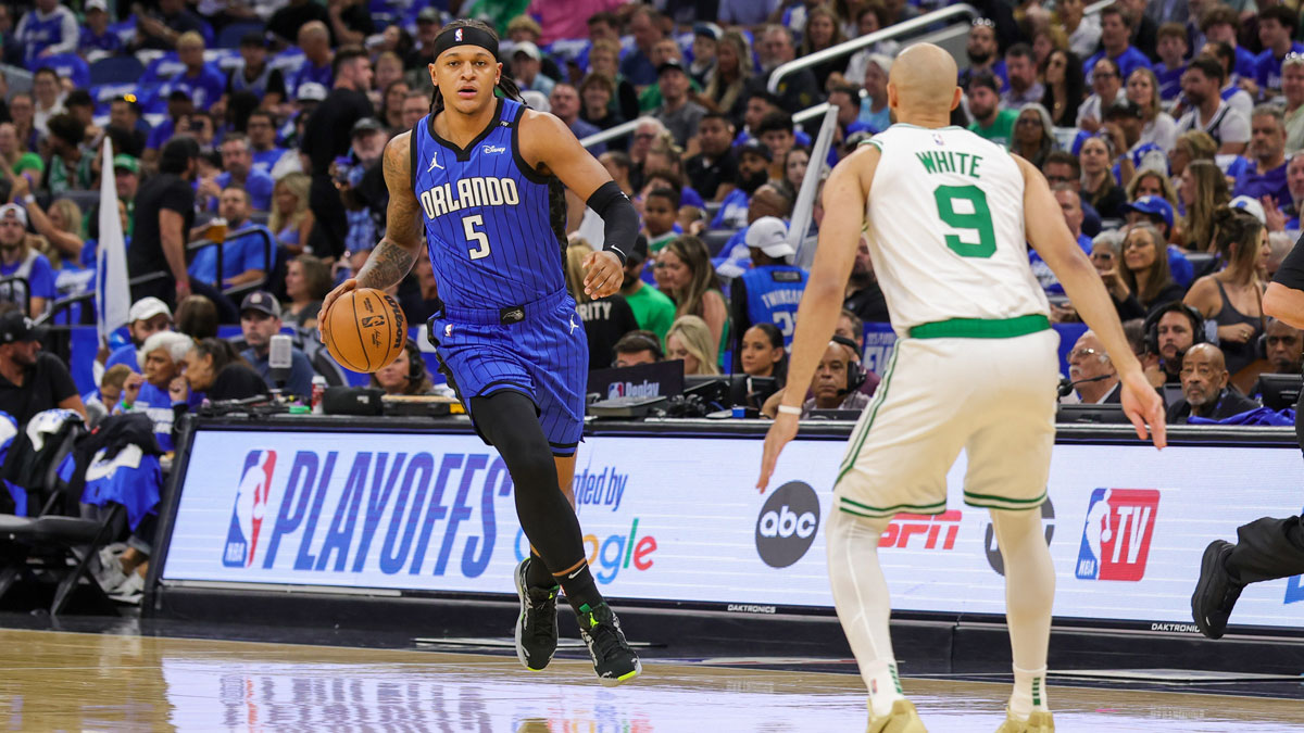 Orlando Magic forward Paolo Banchero (5) brings the ball up court against Boston Celtics guard Derrick White (9) during the first quarter of game three of first round for the 2025 NBA Playoffs at Kia Center.