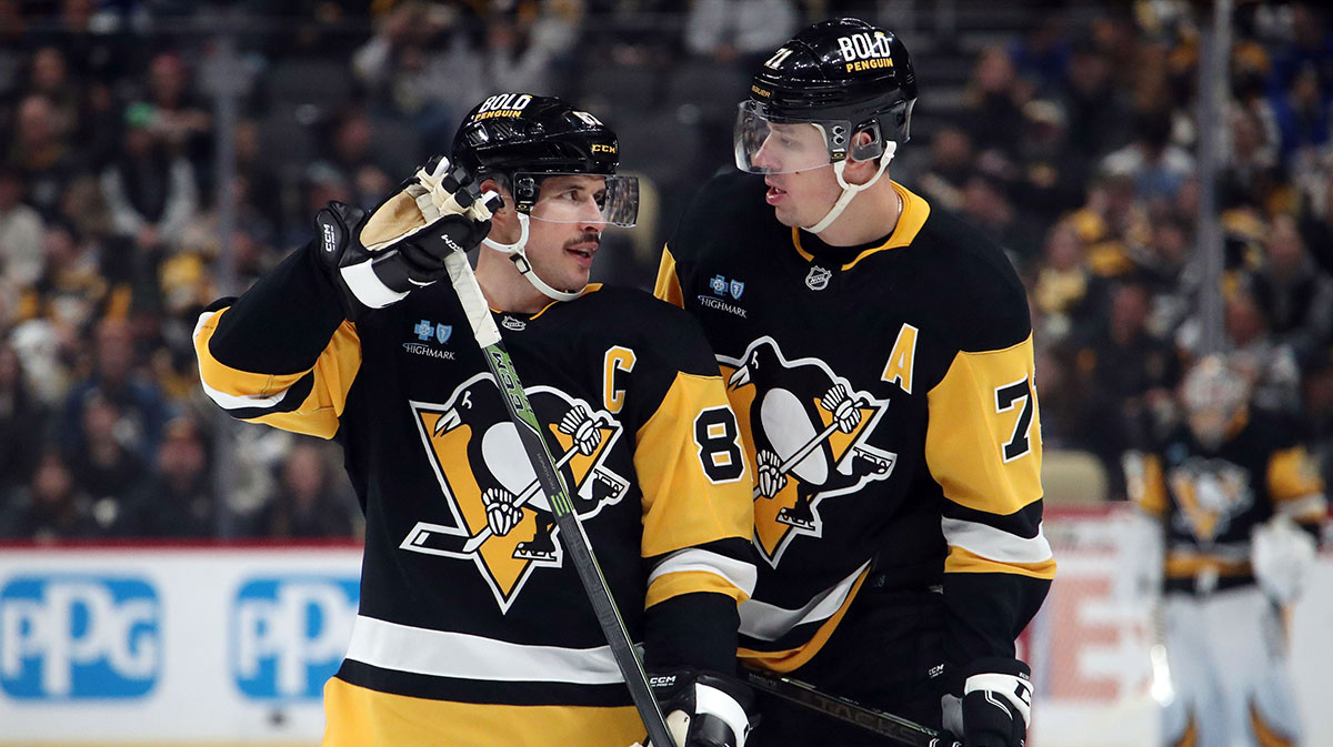 Pittsburgh Penguins center Sidney Crosby (87) and center Evgeni Malkin (71) talk before a face-off against the Vancouver Canucks during the third period at PPG Paints Arena.