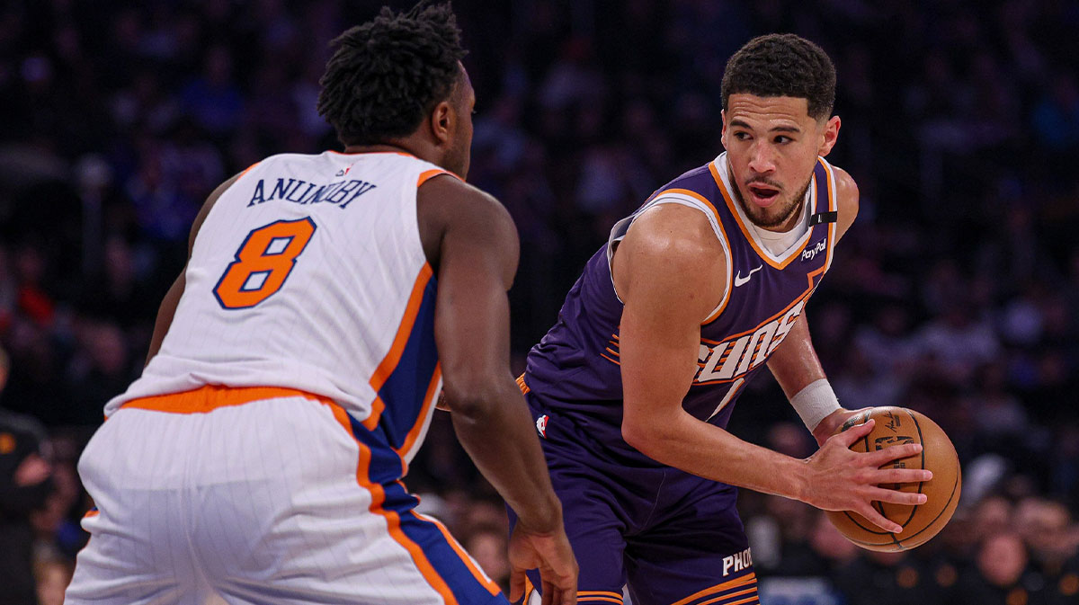 Phoenix Suns guard Devin Booker (1) is guarded by New York Knicks forward OG Anunoby (8) during the first half at Madison Square Garden.