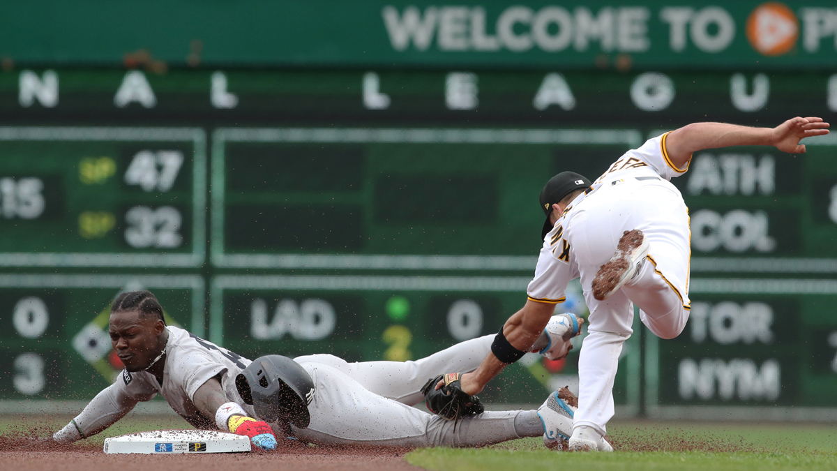 New York Yankees second baseman Jazz Chisholm Jr. (left) steals second base ahead of a tag attempt by Pittsburgh Pirates shortstop Isiah Kiner-Falefa (right) during the second inning at PNC Park