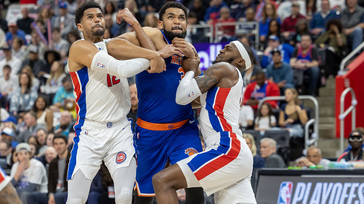 New York Knicks center Karl-Anthony Towns (32) battles for position between Detroit Pistons forward Tobias Harris (12) and forward Paul Reed (7) during the first quarter of game four of first round for the 2025 NBA Playoffs at Little Caesars Arena.