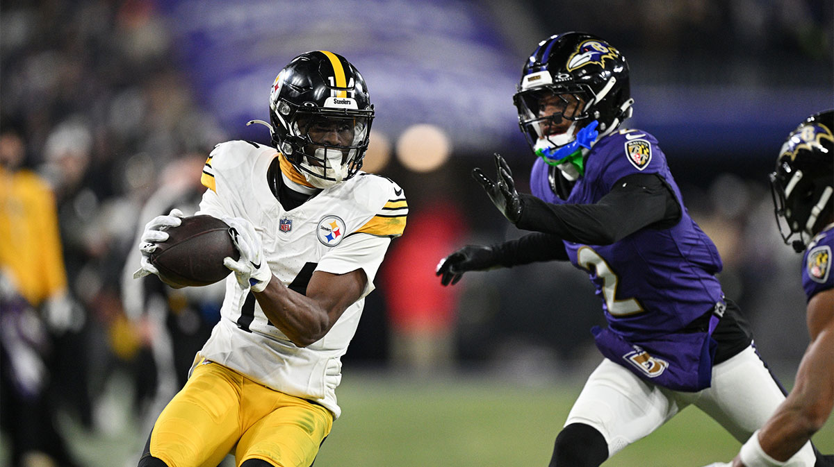 Pittsburgh Steelers wide receiver George Pickens (14) makes a catch against Baltimore Ravens cornerback Nate Wiggins (2) in the third quarter in an AFC wild card game at M&T Bank Stadium.