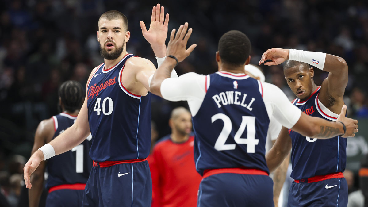 Dec 19, 2024; Dallas, Texas, USA; LA Clippers center Ivica Zubac (40) celebrates with LA Clippers guard Norman Powell (24) and LA Clippers guard Kris Dunn (8) against the Dallas Mavericks during the second half at American Airlines Center. Mandatory Credit: Kevin Jairaj-Imagn Images