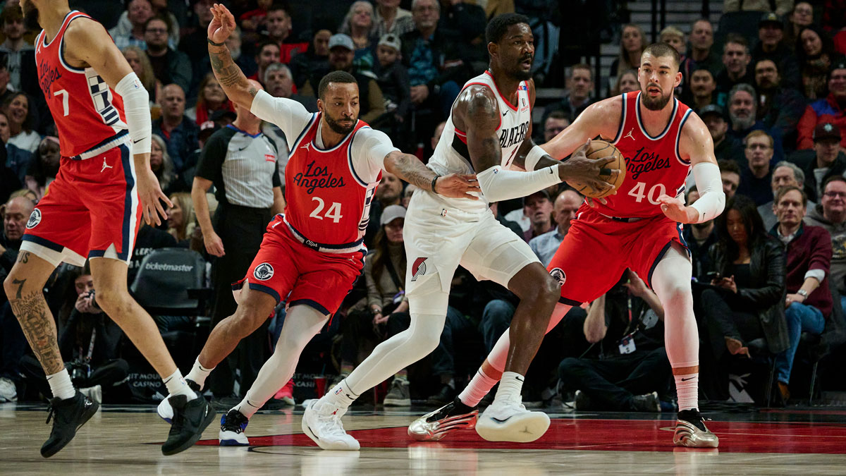 Portland Trail Blazers center Deandre Ayton (2) looks to pass the ball during the first half against LA Clippers guard Norman Powell (24) and center Ivica Zubac (40) at Moda Center.
