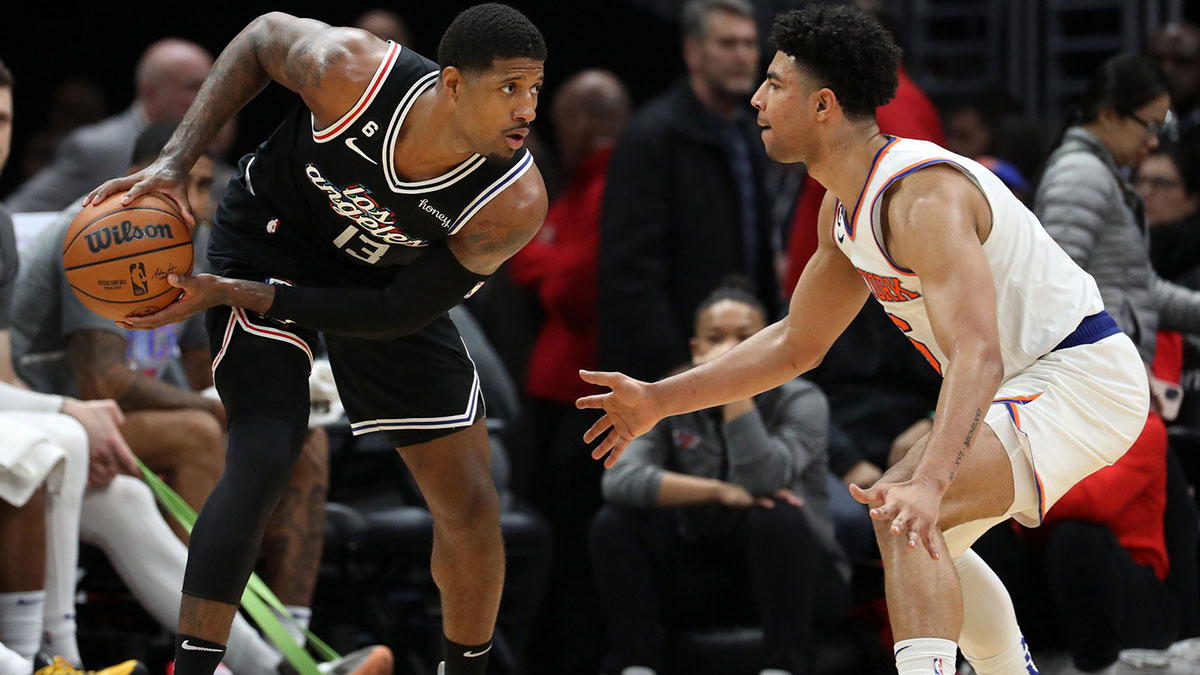 Los Angeles Clippers forward Paul George (13) is defended by New York Knicks guard Quentin Grimes (6) during the second half at Crypto.com Arena.