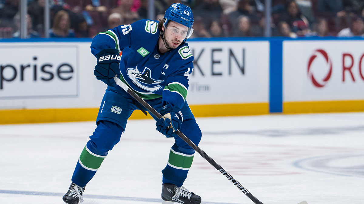 Vancouver Canucks defenseman Quinn Hughes (43) handles the puck against the Minnesota Wild in the second period at Rogers Arena